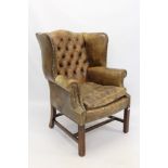 Georgian-style mahogany and leather upholstered wing armchair with brass close-stud upholstery,