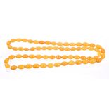 Amber necklace with a long string of oval amber beads, length approximately 90cm.