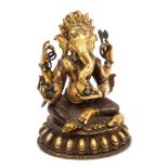 Antique Tibetan gilt bronze figure of Ganesh - finely modelled and applied with a rat at his feet,