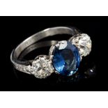 Sapphire and diamond three-stone ring with an oval mixed cut blue sapphire measuring approximately