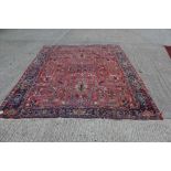 Heriz carpet - allover angular foliate branch-work on blood-red ground in multiple borders,