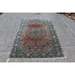 Kashan carpet with central petalled medallion issuing scrolling foliate ornament in multiple