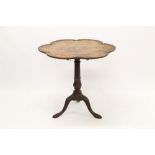 George II-style mahogany tilt-top table with hexafoil dished top raised on carved knopped column