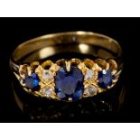 Late Victorian sapphire and diamond ring with three oval mixed cut blue sapphires interspaced by