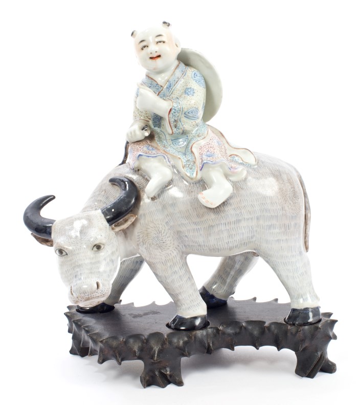 Early 20th century Chinese porcelain figure of a boy on the back of a buffalo,