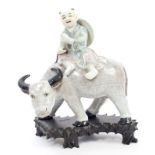 Early 20th century Chinese porcelain figure of a boy on the back of a buffalo,