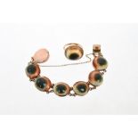 Antique bracelet comprising seven operculum panels in rose gold setting,