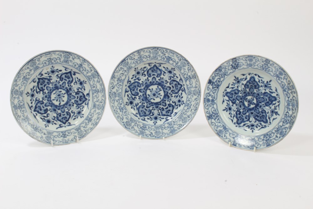 Three 18th century Chinese export blue and white plates with painted floral decoration and precious