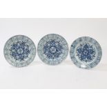 Three 18th century Chinese export blue and white plates with painted floral decoration and precious