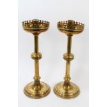 Pair of 19th century ecclesiastical brass candlesticks with crenellated pan on knopped column and