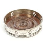 George III silver wine coaster of circular form, with pierced neoclassical oval paterae,