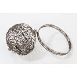 19th century Continental silver wool holder of globular filigree form, with attached wrist bracelet,