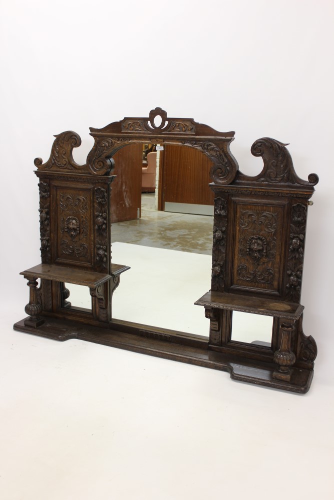 Victorian carved oak overmantel, the central arched mirrored plate below pierced small pediment,