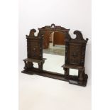 Victorian carved oak overmantel, the central arched mirrored plate below pierced small pediment,