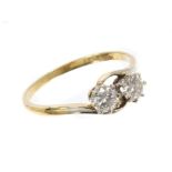 Diamond two stone ring with two brilliant cut diamonds in crossover setting, on 18ct gold shank.