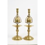 Pair of 19th century brass tavern candlesticks, each with baluster stem centred by pivoting bell,