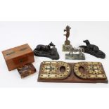 Pair of antique bronzed paperweights in the form of reclining dogs, on shaped bases, 17cm long,