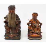 Two late 19th century Chinese carved wooden and polychrome figures of a scribe and an emperor on