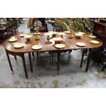 19th century Continental mahogany D-end extending dining table raised on scroll applied frieze and