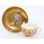 Mid-18th century Meissen gold ground tea cup and saucer with polychrome painted floral sprays -