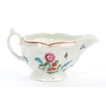 18th century Worcester moulded sauce boat, circa 1770, with polychrome painted floral decoration,