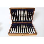 Set of twelve pairs 1920s dessert knives and forks (two forks a/f) with silver blades and mother of