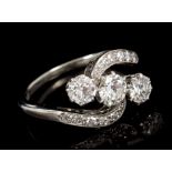 Diamond three stone ring with three old European cut diamonds in a crossover setting with single