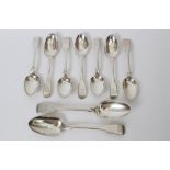 Seven Georgian and Victorian silver fiddle pattern dessert spoons with engraved armorial crests and