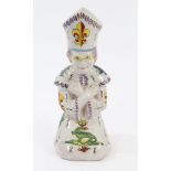 Early 20th century French faience candlestick in the form of a kneeling praying clergyman,