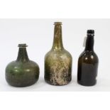 Two 18th century green glass wine bottles with string collars and green iridescence,