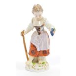 Late 19th century Meissen porcelain figure of a girl with a hoe and holding a bunch of grapes -