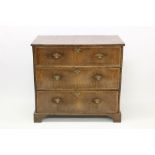 Early 18th century walnut crossbanded chest of three long drawers, on bracket feet,