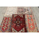 Group of five rugs - to include a Persian runner