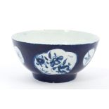 18th century Lowestoft blue and white bowl with chinoiserie figure and floral reserves on
