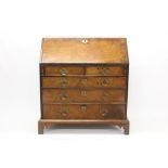 George II walnut crossbanded, feather-strung bureau,