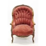 Victorian walnut tub chair with button upholstered red velvet back and seat in foliate carved