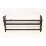 Unusual early 20th century carved oak hanging shelves with two guilloche carved shelves,