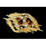 1970s 18ct gold diamond and ruby pendant brooch in the manner of Andrew Grima,