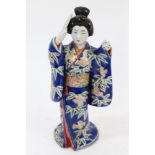 Late 19th century Japanese porcelain figure of a Geisha girl with fan, with polychrome decoration,