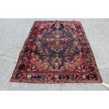 Persian Lilian rug - aubergine field centred by foliate medallion within foliate borders,