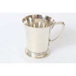 Contemporary silver christening mug of waisted form, with loop handle,