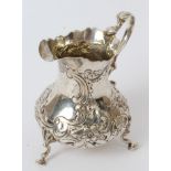 Victorian silver cream jug of baluster form, with later chased floral decoration and scroll handle,