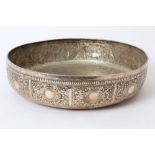 Large Far Eastern white metal bowl of circular form, with panels of embossed foliate decoration,