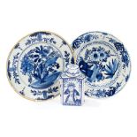 Two 18th century Delft blue and white tin glazed pottery plates with painted floral decoration,