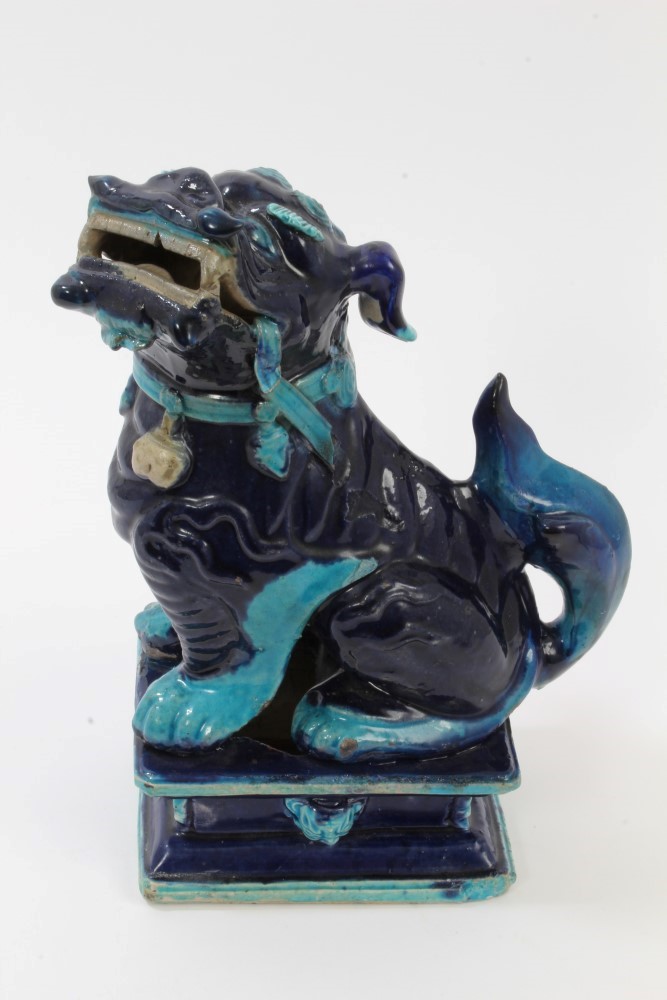 Antique Chinese blue glazed porcelain temple dog, raised on stand with lion mask mounts,