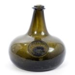 Fine early 18th century green glass seal bottle of mallet form,
