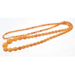 Old amber necklace with a long string of graduated butterscotch amber beads,