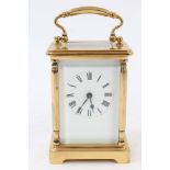 Contemporary brass carriage clock with white enamel dial and brass swing handle,