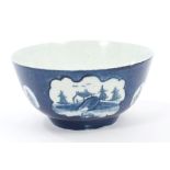 18th century Lowestoft blue and white bowl with chinoiserie landscape and floral reserves on