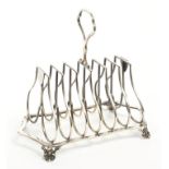 Edwardian silver six-division toast rack of shaped form, with central carrying handle,